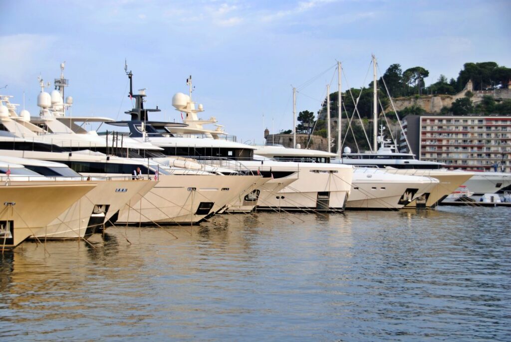 Elegant yachts moored in the scenic harbor of Monaco, showcasing luxury and exclusivity.